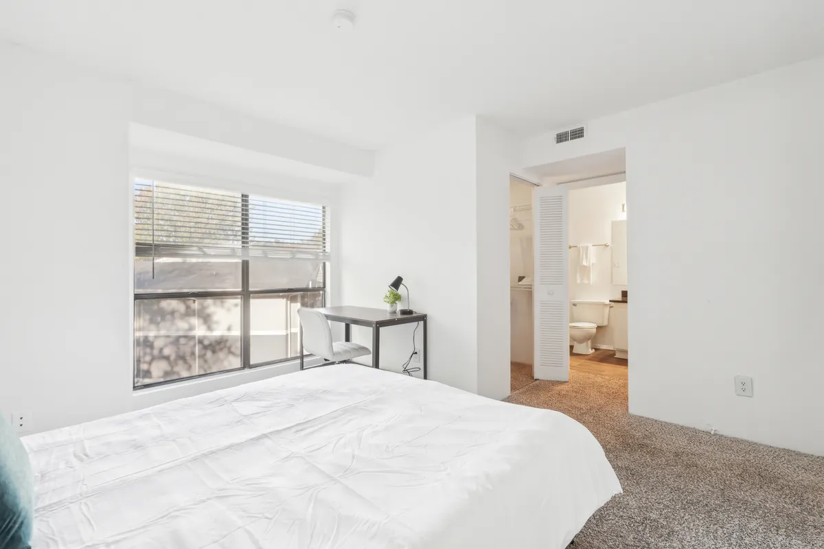 A peaceful bedroom with a bed, a desk by the window, and a tranquil atmosphere, ideal for unwinding, reading, or planning the next day's adventure. The overall mood is quiet and restful.